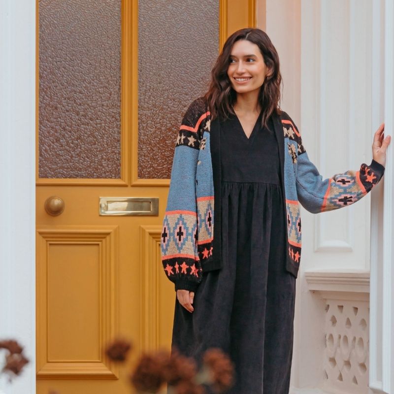 woman standing by a door 