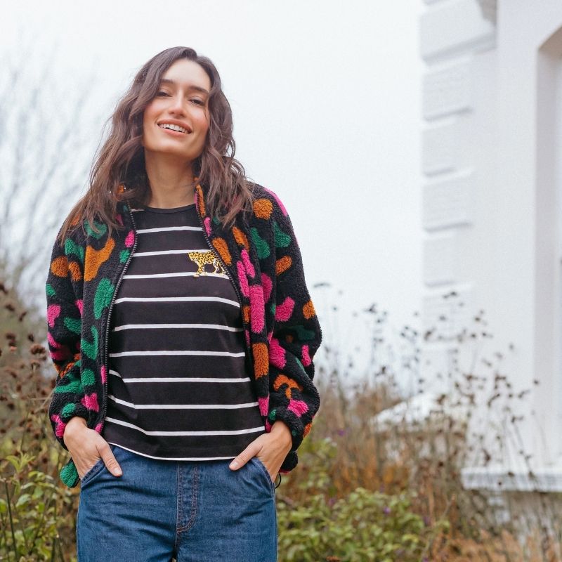 a woman wearing a colourful fleece 