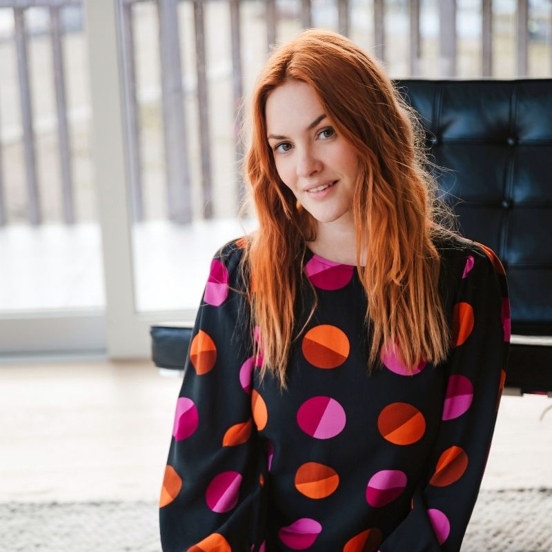 a woman posing with polka dot top on 