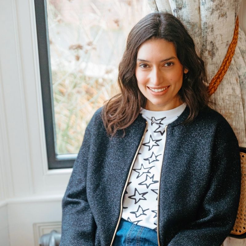 a woman modelling a glittery bomber jacket