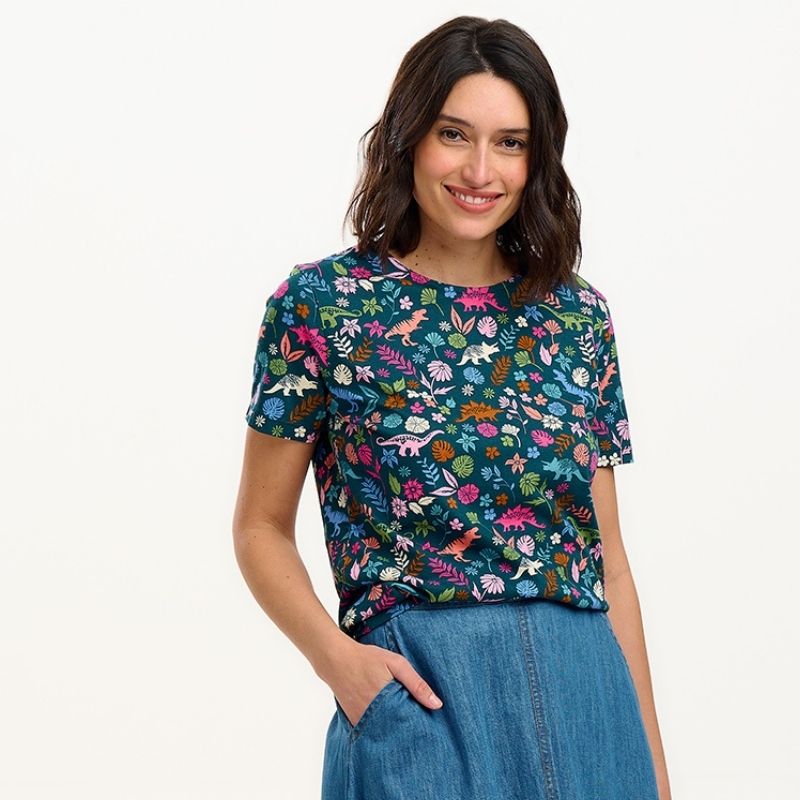 a woman wearing a dinosaur print top 