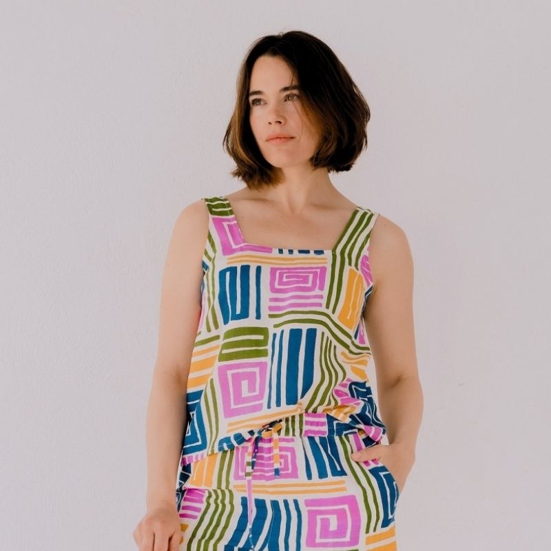 a close up of a model in  a bright coloured top