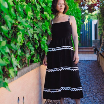 a woman wearing a black sundress