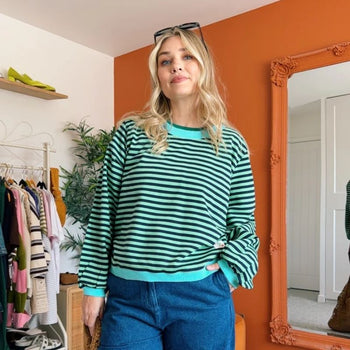 a woman wearing a stripe top