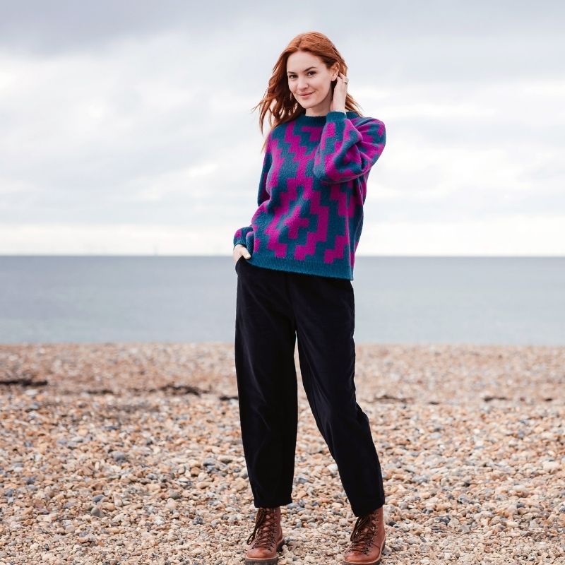 A woman modelling a jumper on the beach 