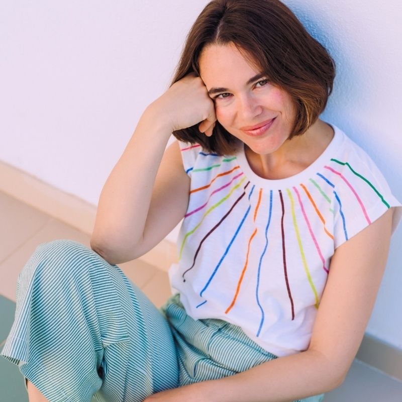 a woman weraing a colourful strip top 