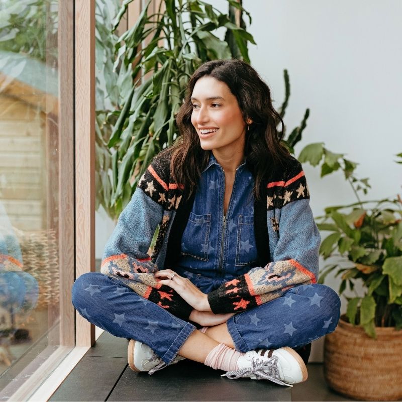 woman sitting on windowsil smiling 