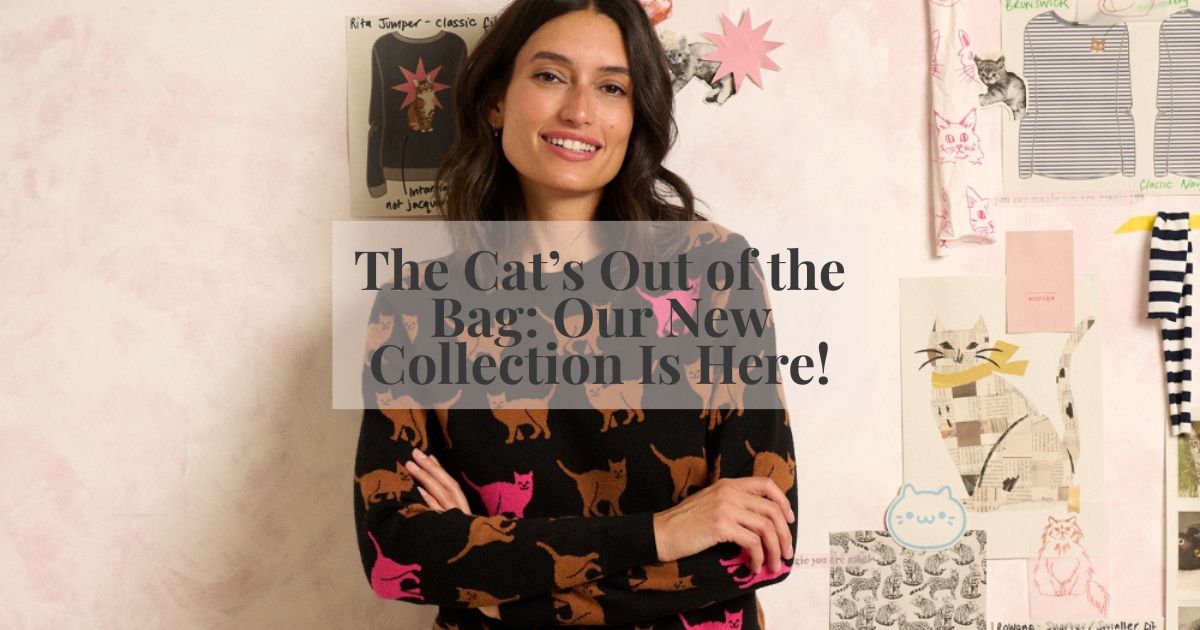 WOMAN MODCELLING A BLACK JMPER WITH CATS ON 