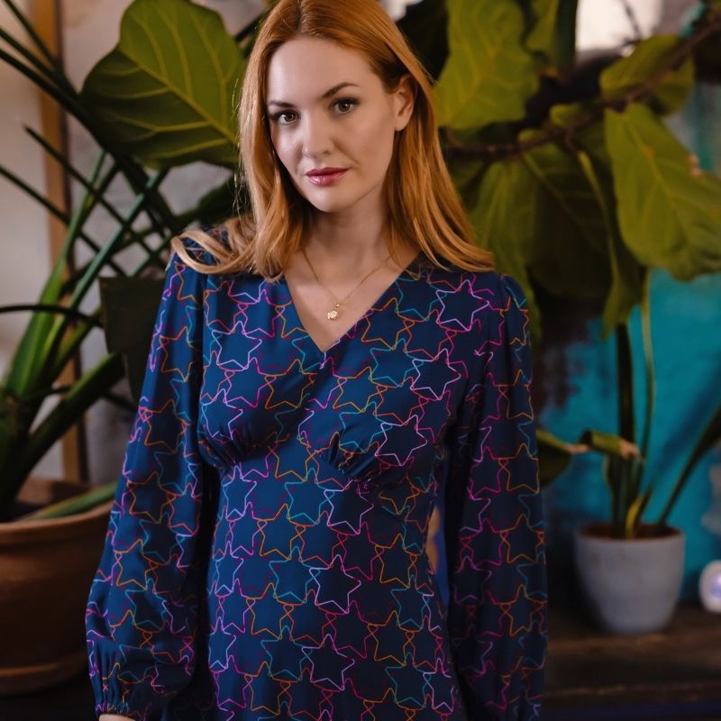 a model wearingt a snake print bomber jacket 