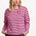 Sugarhill brighton model wearing a pink and black striped sweater with a star accessory on a white background