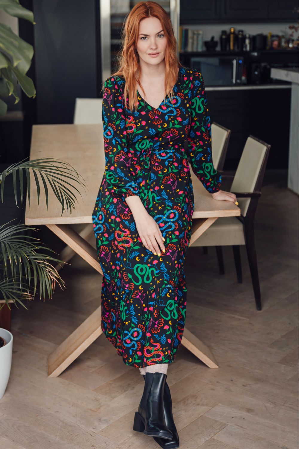 Woman in a colorful dress standing in a kitchen