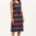 A model wearing a sleeveless midi dress with a wavy chevron stripe pattern in black, teal, navy, tan, pink, and coral colors.