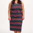 A model wearing a sleeveless midi dress with a wavy chevron stripe pattern in black, teal, navy, tan, pink, and coral colors.