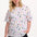 Sugarhill Brighton model wearing a white t-shirt with colorful abstract pattern on a white background