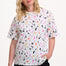 Sugarhill Brighton model wearing a white t-shirt with colorful abstract pattern on a white background