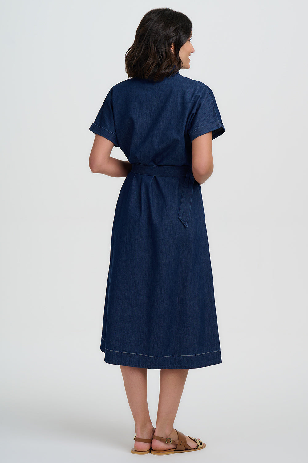 Woman wearing a navy blue dress on a white background