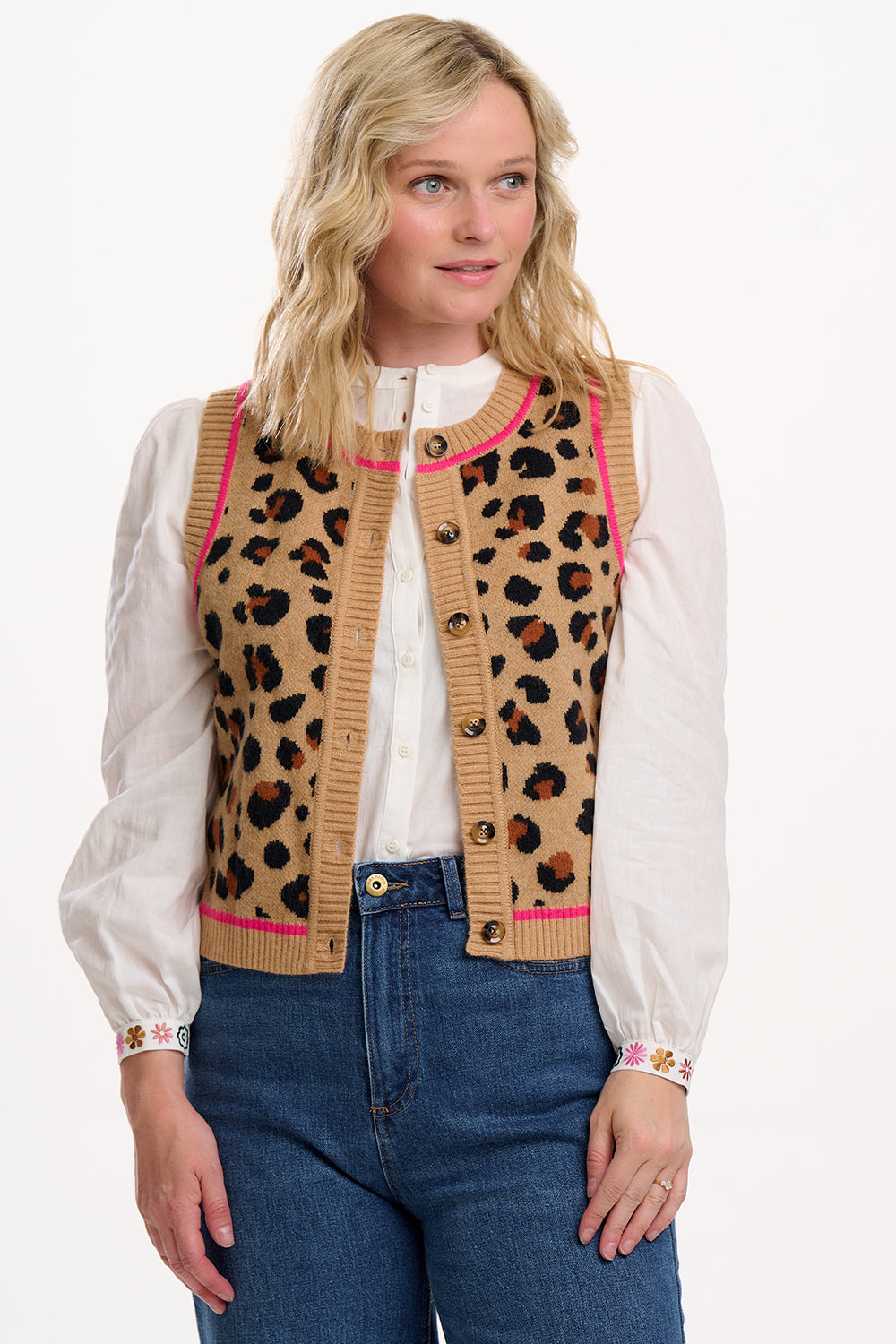 Sugarhill Brighton model wearing a leopard print cardigan with pink trim on a white background