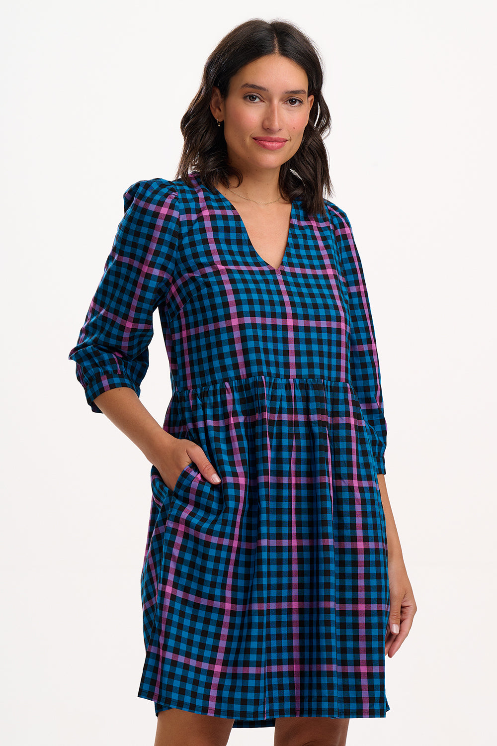 Sugarhill Brighton model wearing a blue and pink plaid dress on a white background