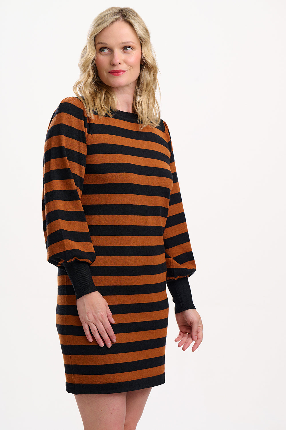 Woman wearing a brown and black striped dress on a white background