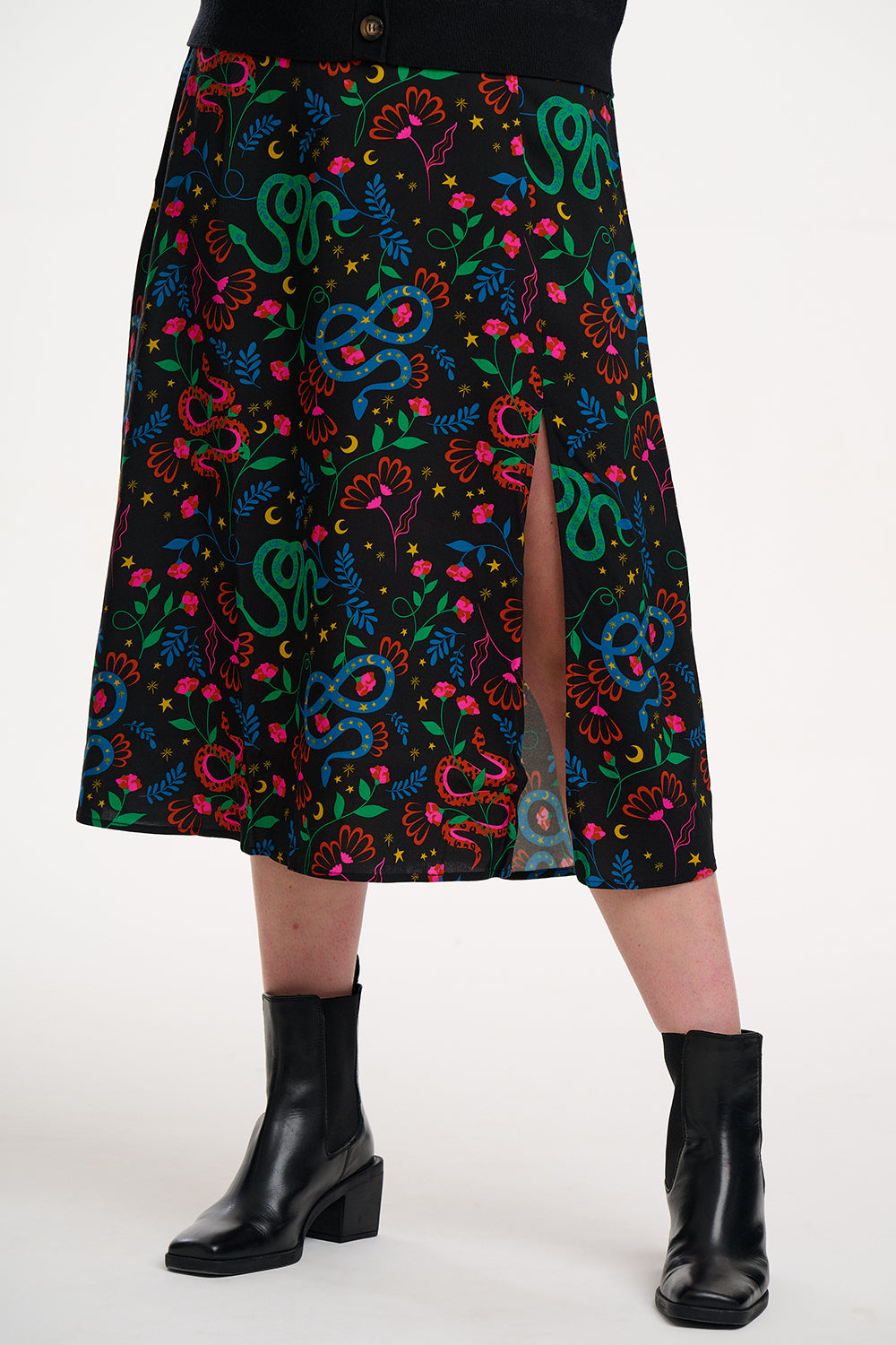 Skirt with colorful snake pattern worn by a person on a white background