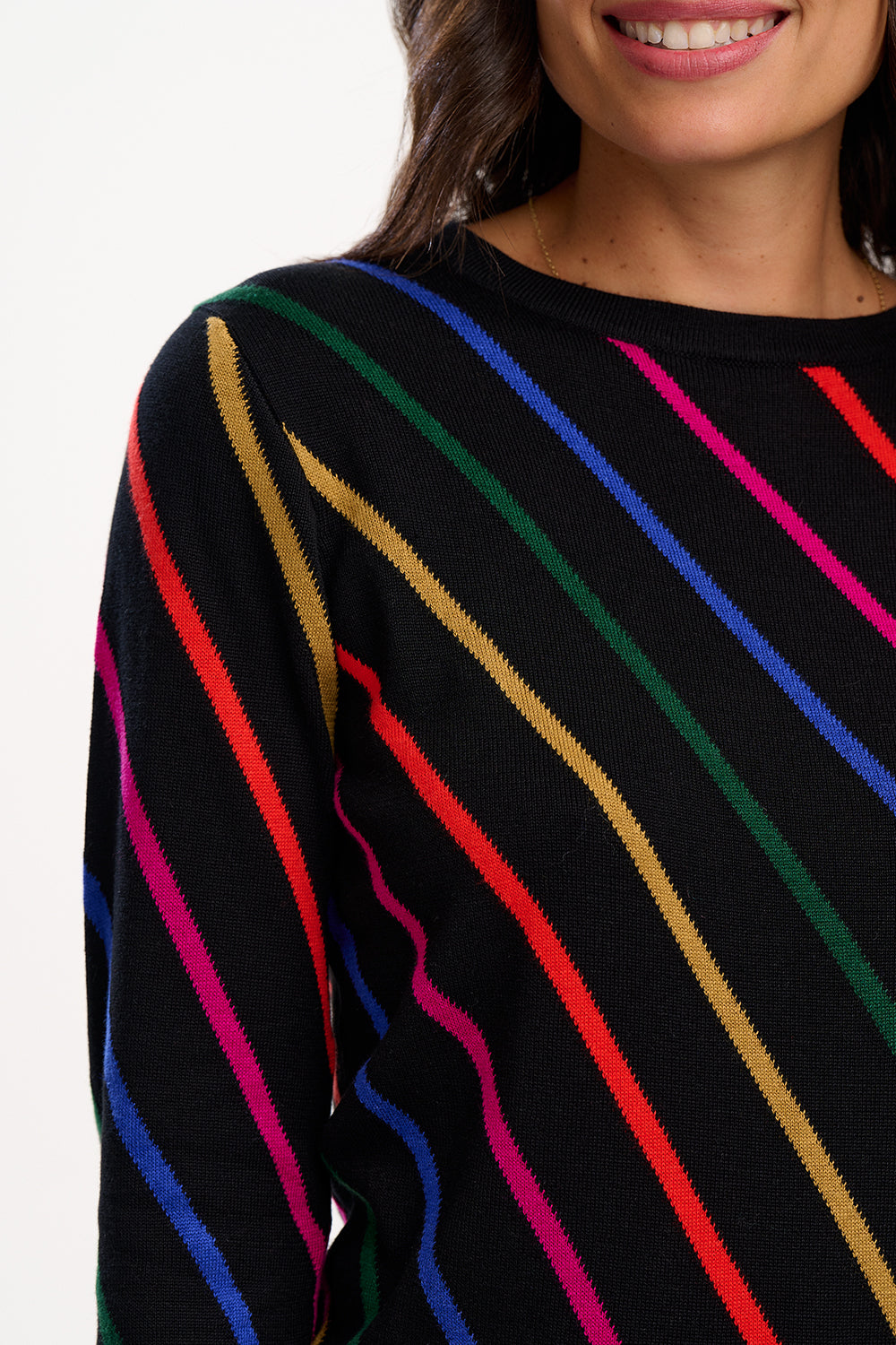 Black sweater with colorful diagonal stripes worn by a person.