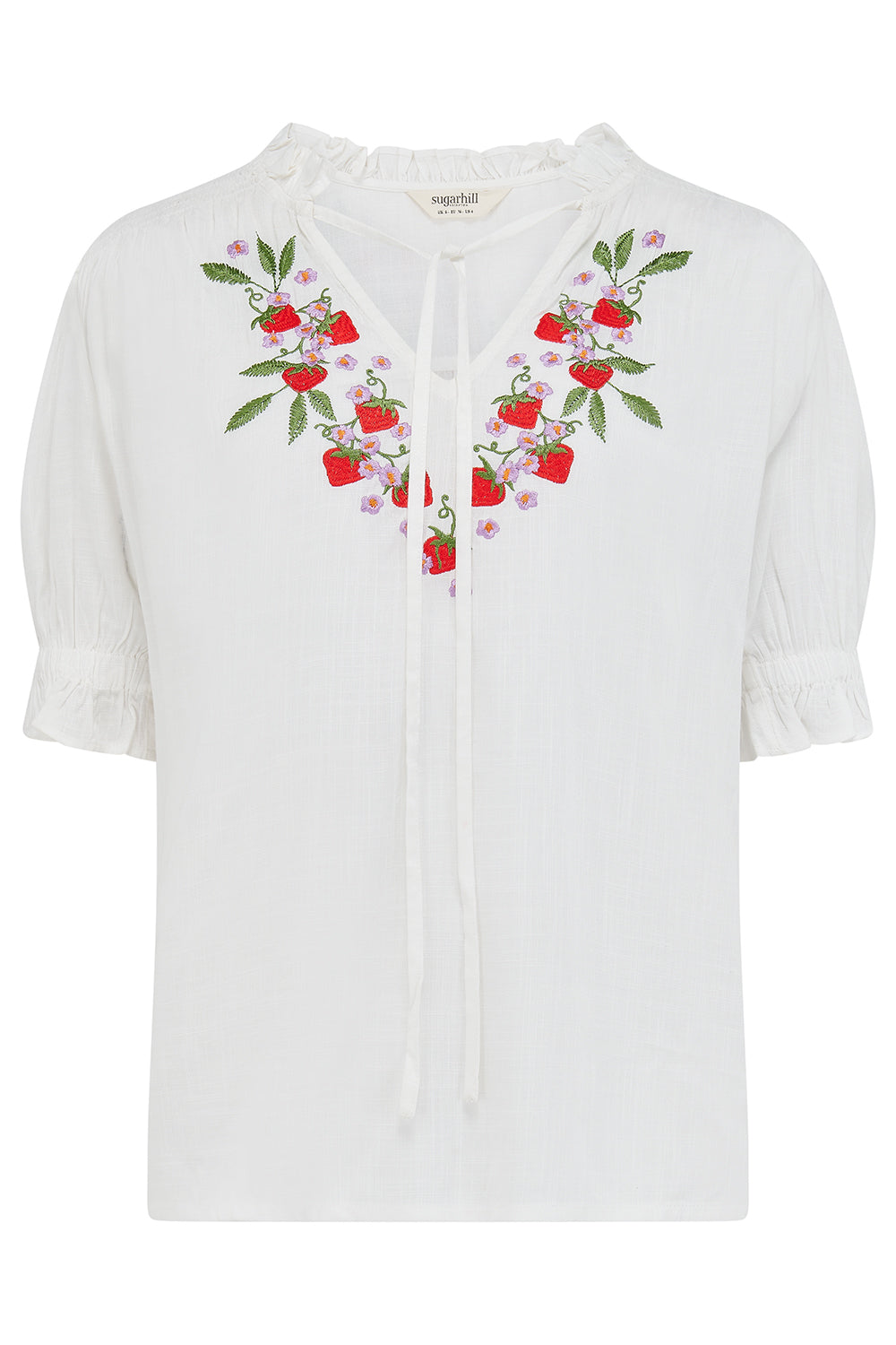 White blouse with floral embroidery on a white background
