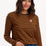 Sugarhill Brighton - model wearing a black and orange striped long-sleeve shirt with a small logo on a white background