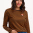 Sugarhill Brighton - model wearing a black and orange striped long-sleeve shirt with a small logo on a white background