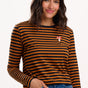 Sugarhill Brighton - model wearing a black and orange striped long-sleeve shirt with a small logo on a white background