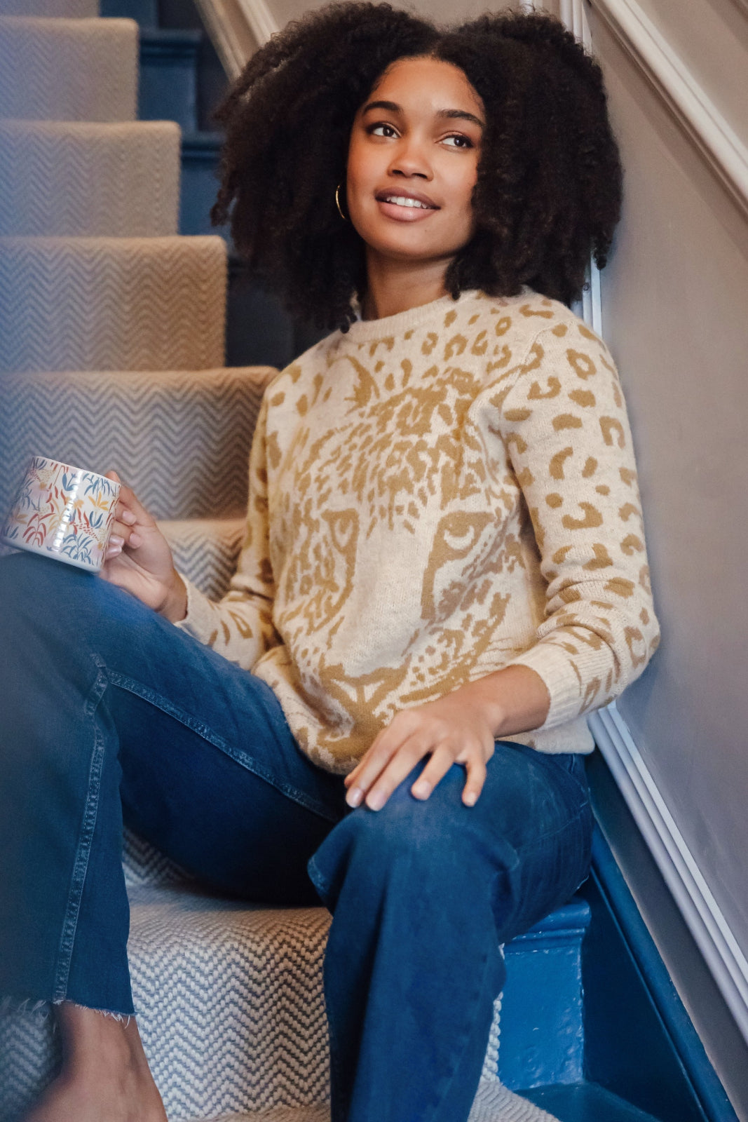model wearing jumper with large leopard face on it 