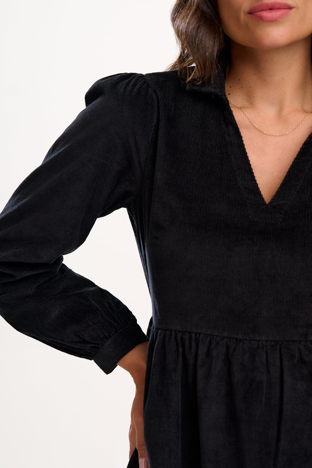 Black dress with long sleeves on a plain background