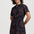 Woman wearing a black dress with red patterns on a white background
