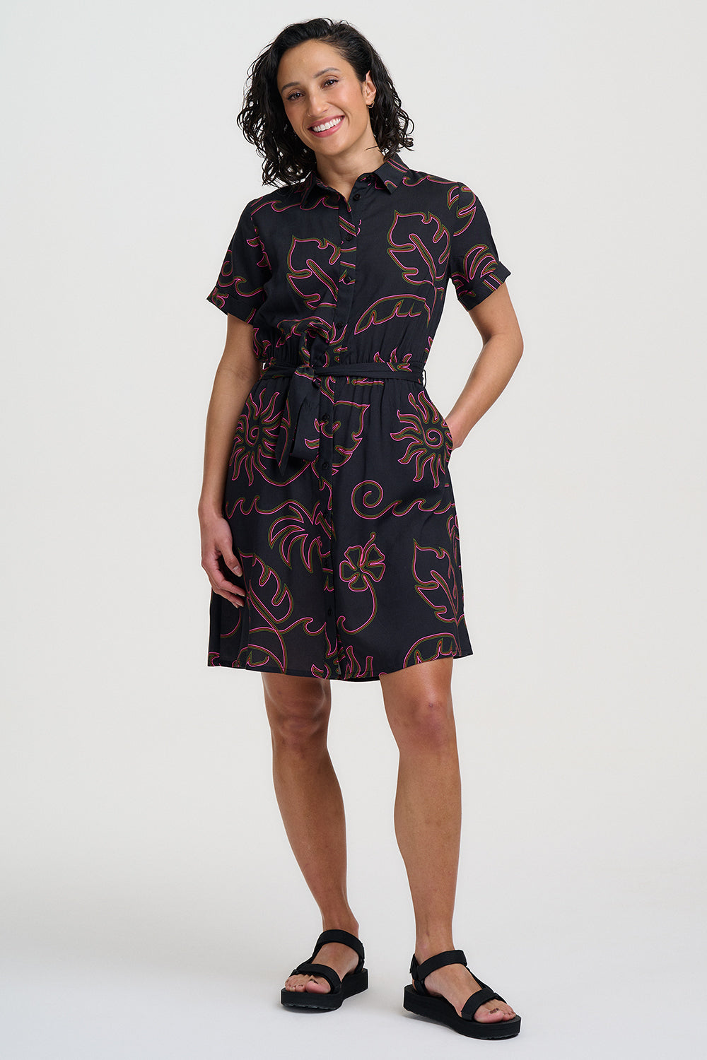 Woman wearing a black dress with red patterns on a white background