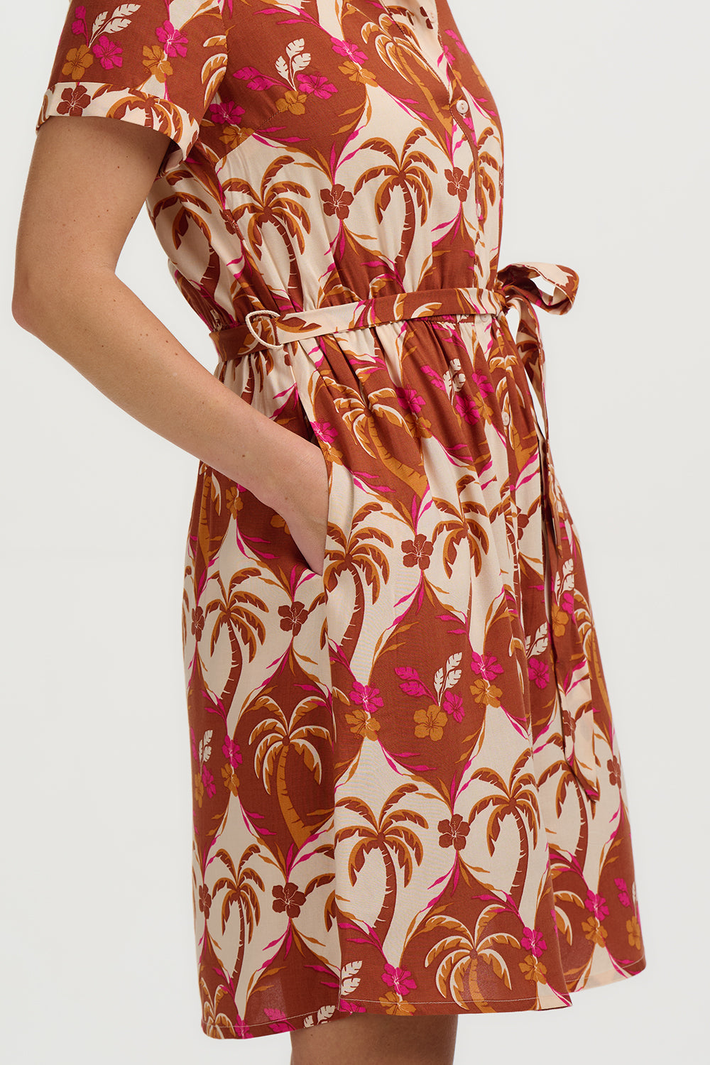 Dress with palm tree pattern on a plain background
