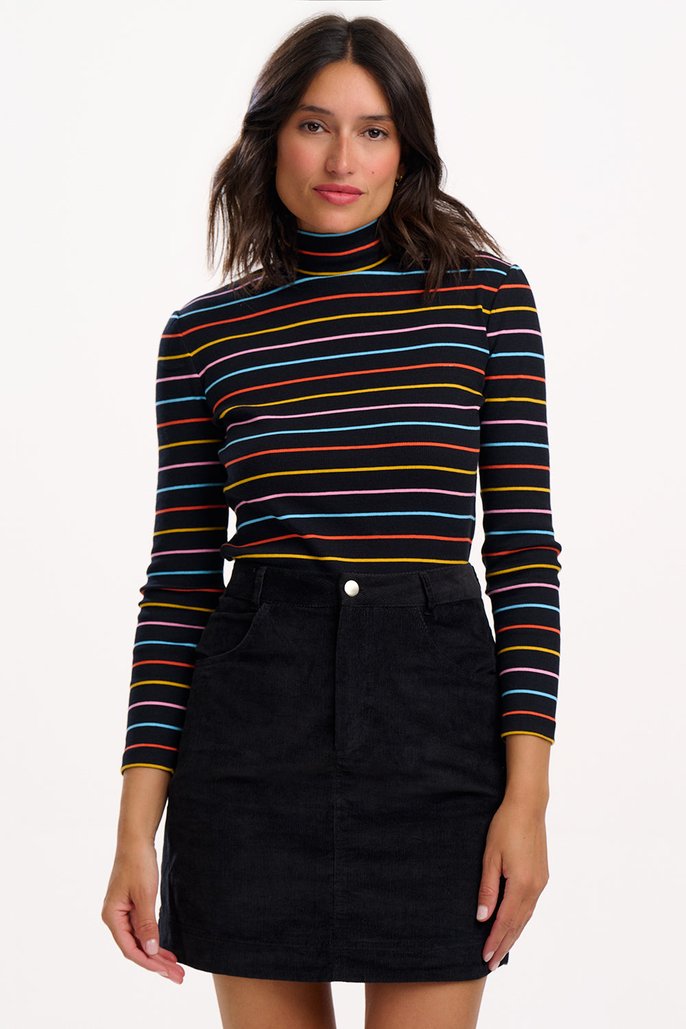 Woman wearing a striped long-sleeve top and black skirt on a white background