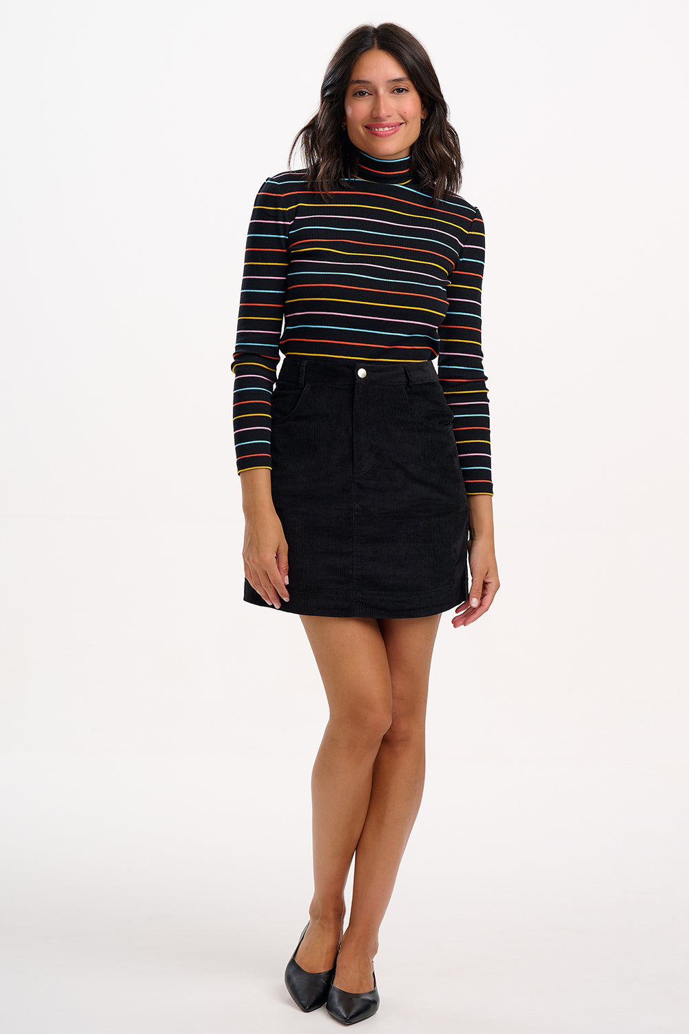 Woman wearing a striped sweater and black skirt on a white background