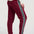 Woman wearing burgundy pants with white stripes on a white background