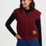 Woman wearing a red vest with a logo on a white background