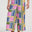 Multicolored geometric patterned pants worn by a person on a white background