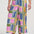 Multicolored geometric patterned pants worn by a person on a white background