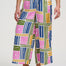 Multicolored geometric patterned pants worn by a person on a white background
