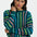 Woman wearing a colorful striped sweater against a white background