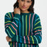 Woman wearing a colorful striped sweater against a white background