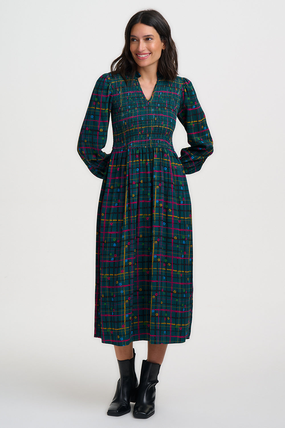 Woman wearing a plaid dress on a white background