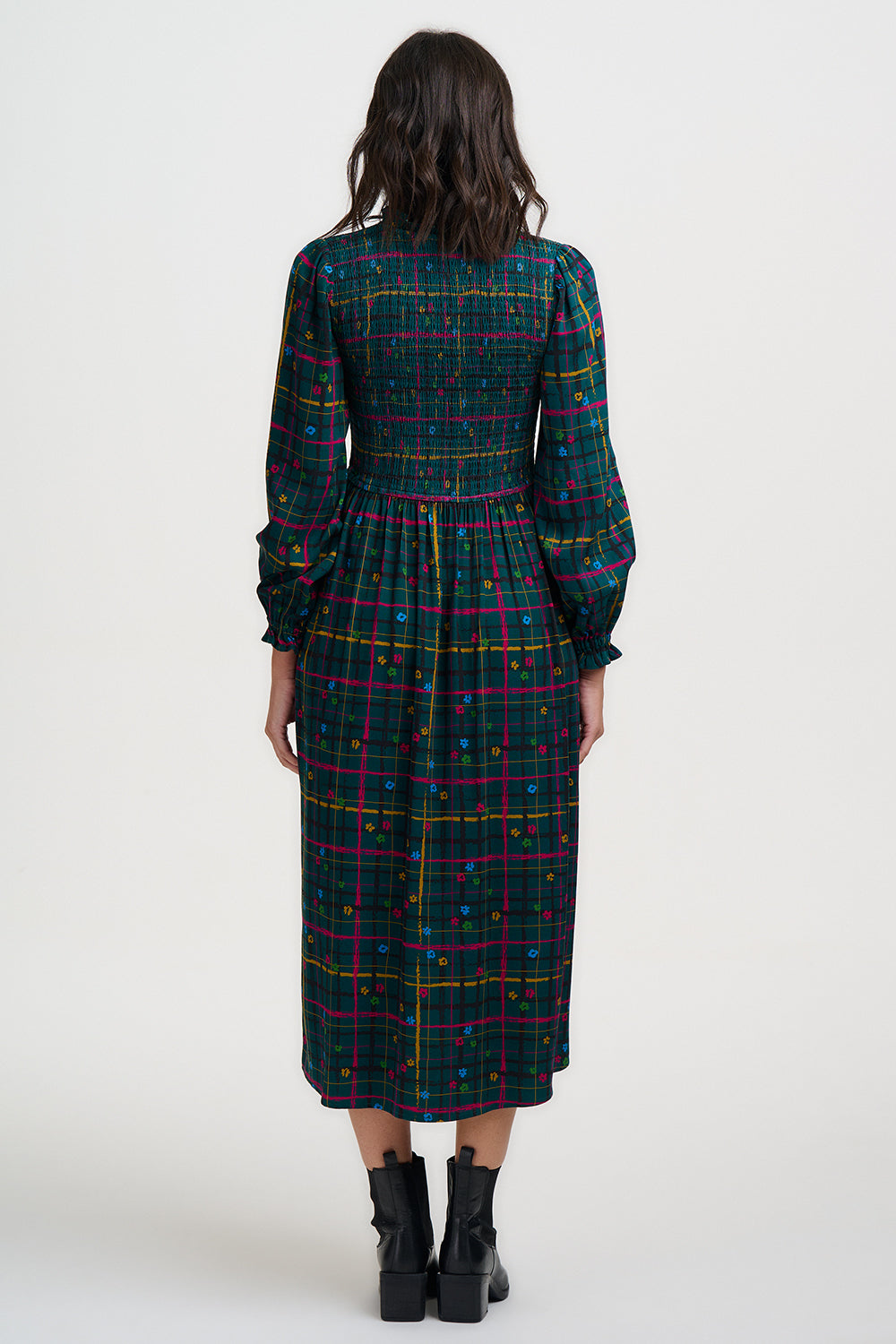 Woman wearing a plaid dress with a white background