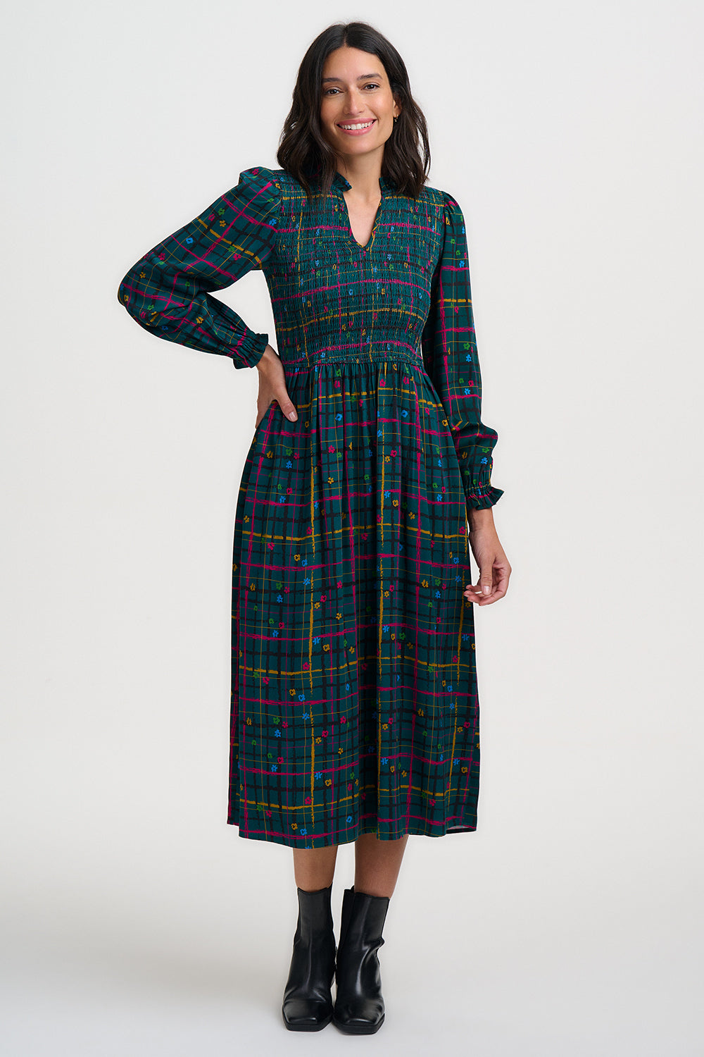 Woman wearing a plaid dress on a white background