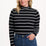 Sugarhill Brighton Sugarhill Brighton Annika Jersey Top - Black/White, Stripe Lightning. Woman wearing a black and white striped sweater with blue jeans on a white background
