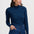 Woman wearing a blue and black striped long-sleeve top and blue jeans against a white background