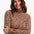 Sugarhill Brighton - model wearing a leopard print long-sleeve top with a red heart on a white background