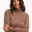 Sugarhill Brighton - model wearing a leopard print long-sleeve top with a red heart on a white background